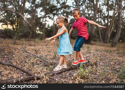 Two kids playing in the forest