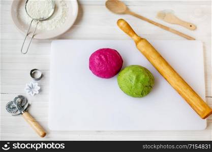 Two kinds of dough on the board. Homemade cooking pasta with spinach and beetroot. The concept of healthy eating.. Two kinds of dough on the board. Homemade cooking pasta with spinach and beetroot.