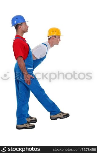 Two laborer standing in shape of K letter