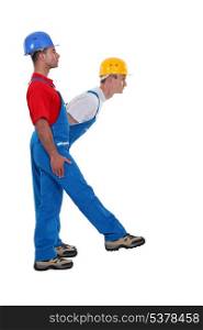 Two laborer standing in shape of K letter