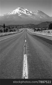 Two lane road heads west across California Mountain Landscape