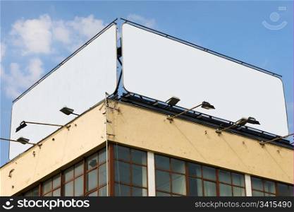 Two large blank billboards with copy space on a building roof