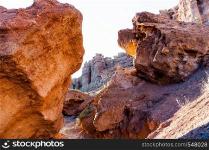 Two large stone from the red rocks form an arch and pass to Charyn canyon. Kazakhstan.. Two large stone from the red rocks form an arch and pass to Charyn canyon. Kazakhstan
