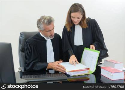Two legal working looking through files