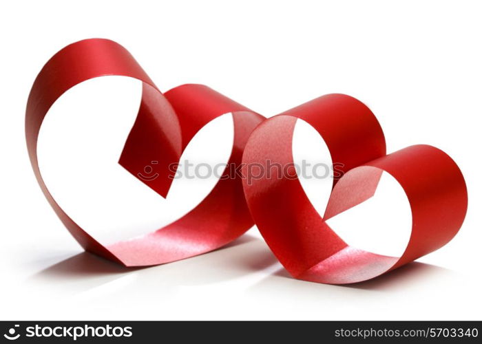 Two linked hearts of red ribbon isolated on white background