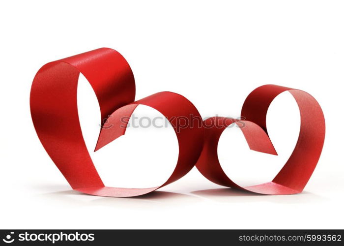 Two linked hearts of red ribbon isolated on white background