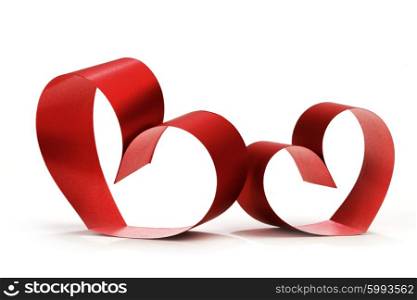 Two linked hearts of red ribbon isolated on white background