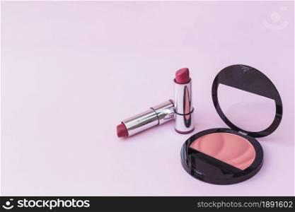 two lipsticks pink blusher pink background. Resolution and high quality beautiful photo. two lipsticks pink blusher pink background. High quality and resolution beautiful photo concept