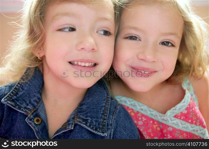 Two little beautiful toddler twin sisters portrait