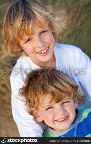 Two Little Boys, Brothers, Together on A Sunny Beach