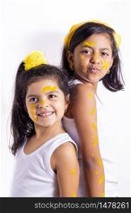 Two little girl, with her face painted to celebrate the yellow day