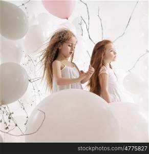 Two little girls among the balloons