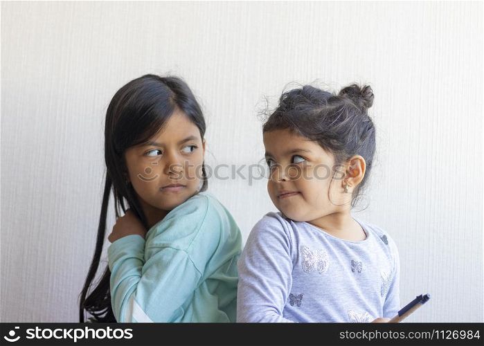 Two little girls looking at each other
