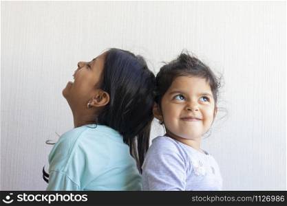 Two little girls looking at each other