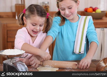 two little girls making pancakes