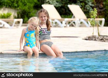 two little girls near the open-air swimming pool