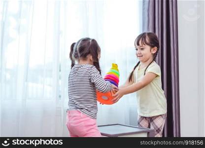 Two little girls playing small toy balls in home together. Education and Happiness lifestyle concept. Funny learning and Children development theme. Group of kids