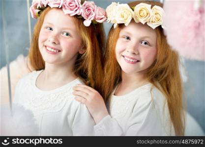 Two little redhead twin sisters together