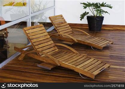 Two lounge chairs in a patio of a house