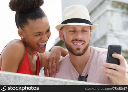 two lovers making a selfie photo in a city