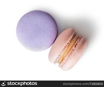 Two macaroon purple beige top view on white background. Two macaroon purple beige top view