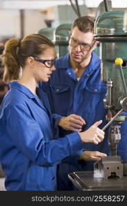 Two machinists working on machine