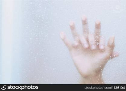 two male and female Couple lovers holding hands having sex inside showers bathroom mirror with a steamy window. soft focus. Leave copy space empty to write text on the side.
