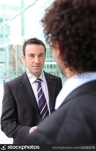 Two male businessmen shaking hands