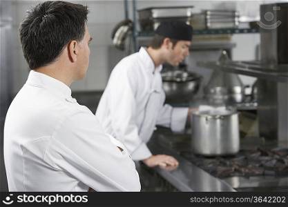 Two male chefs working in kitchen