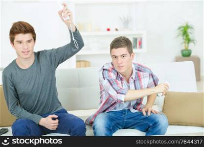Two male friends playing video games