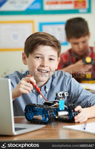 Two Male Pupils In Science Lesson Studying Robotics