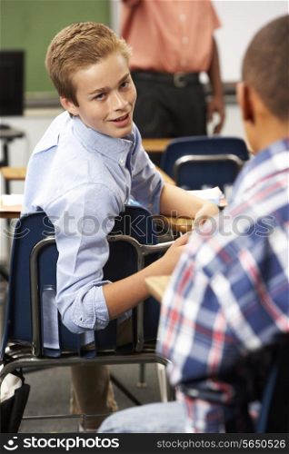 Two Male Pupils Talking In Class