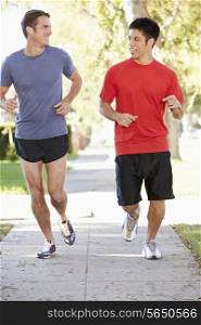 Two Male Runners Exercising On Suburban Street
