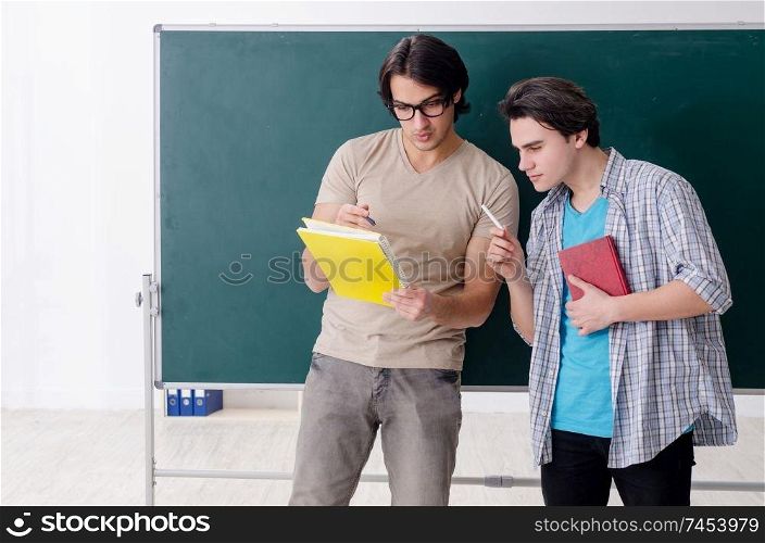 Two male students in the classroom 