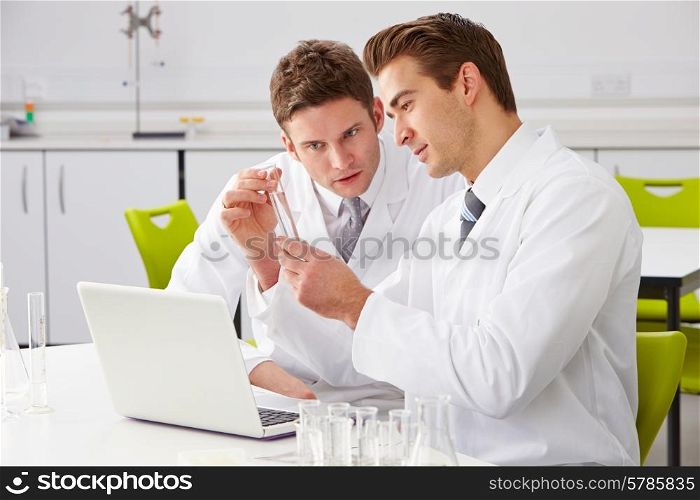 Two Male Technicians Working In Laboratory