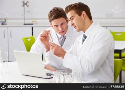 Two Male Technicians Working In Laboratory