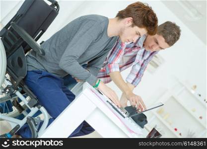 Two male teenagers studying at home