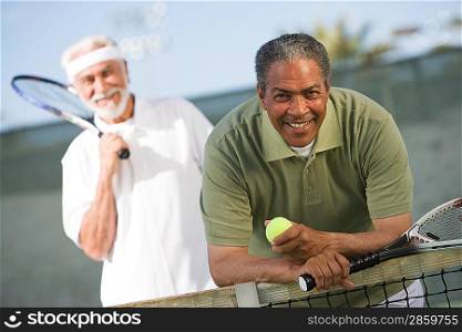 Two male tennis players on court
