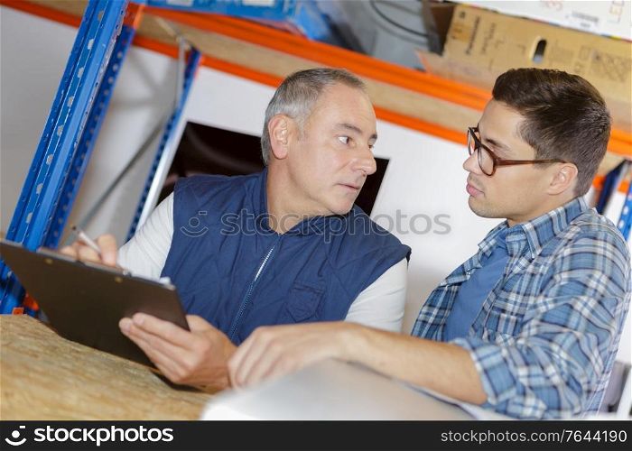 two male workers in warehouse
