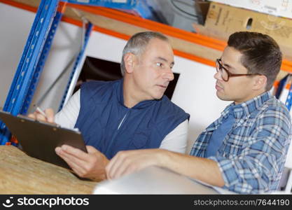 two male workers in warehouse