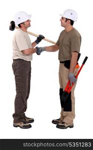 Two manual worker shaking hands.