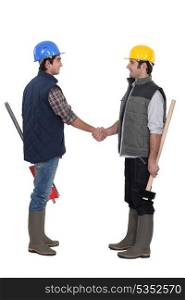 Two manual workers greeting each other