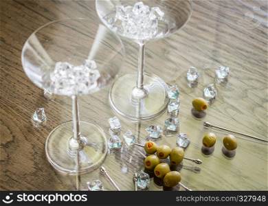 Two martini glasses with olives on martini picks