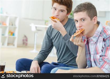 Two mates sharing a pizza