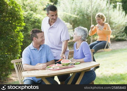 Two mature couples in a lawn