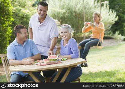 Two mature couples in a lawn