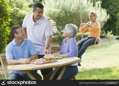 Two mature couples in a lawn