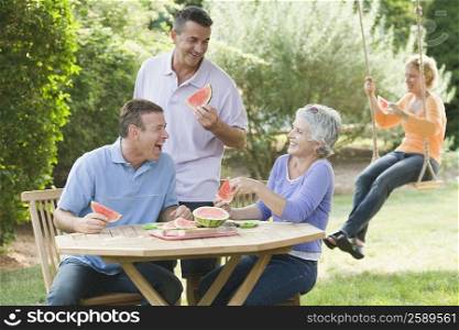 Two mature couples in a lawn