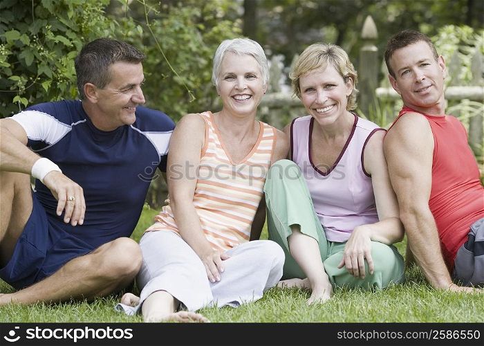 Two mature couples sitting in a park