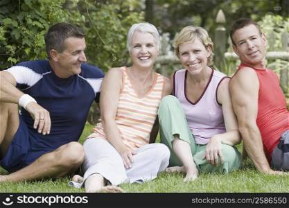 Two mature couples sitting in a park